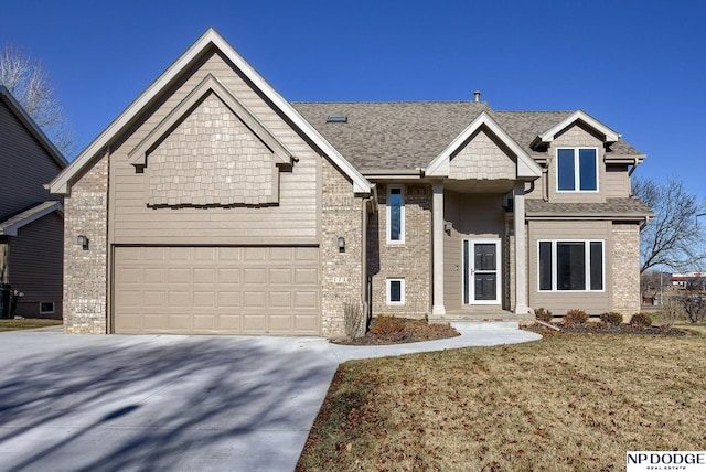 view of front of home featuring a front lawn and a garage