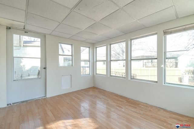 unfurnished sunroom with a paneled ceiling