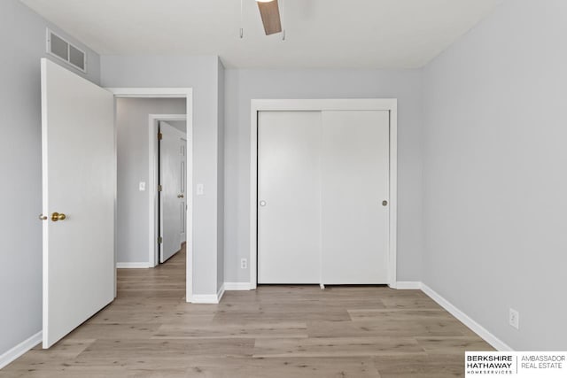 unfurnished bedroom with ceiling fan, a closet, and light hardwood / wood-style flooring