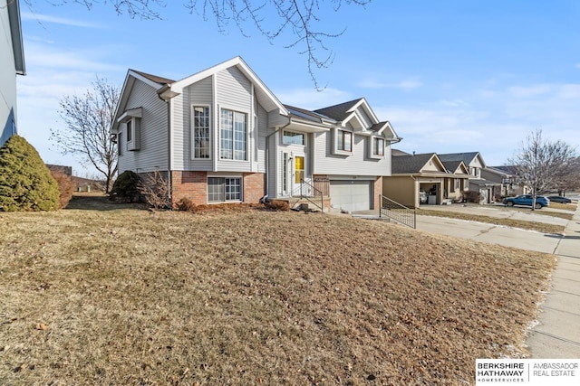 bi-level home with a garage and a front lawn