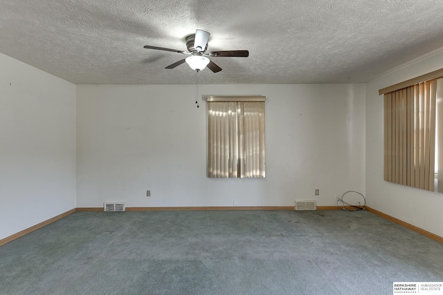 carpeted empty room featuring a textured ceiling and ceiling fan