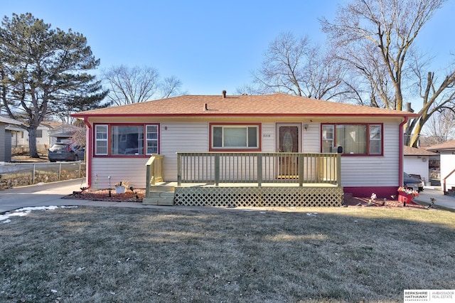 view of front of home with a front lawn and a wooden deck