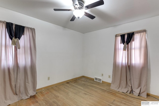 empty room with ceiling fan and light hardwood / wood-style floors