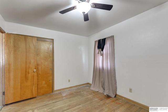 unfurnished bedroom with ceiling fan, light hardwood / wood-style flooring, and a closet