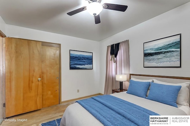 bedroom with ceiling fan, light wood-type flooring, and a closet