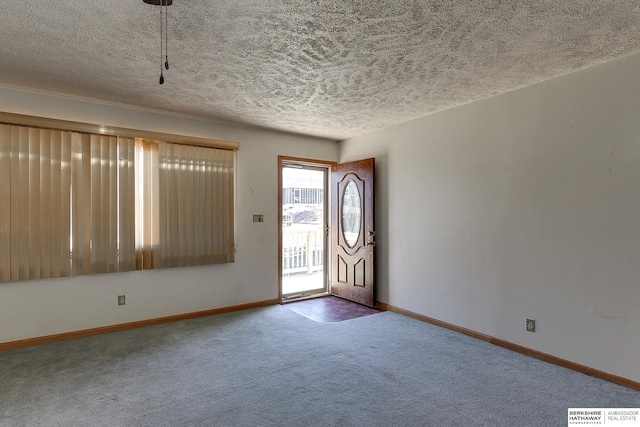 entrance foyer with a textured ceiling and carpet