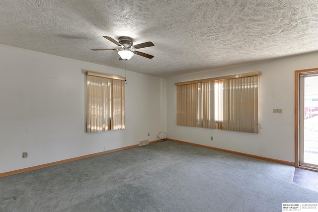 carpeted spare room featuring ceiling fan