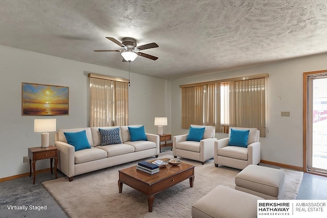 carpeted living room with ceiling fan and a textured ceiling