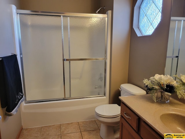 full bathroom featuring toilet, combined bath / shower with glass door, tile patterned flooring, and vanity