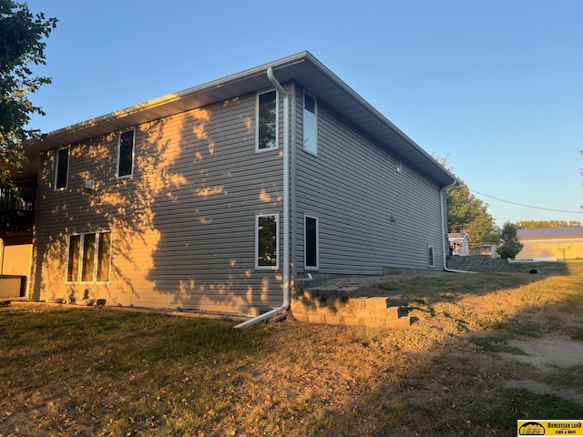 view of property exterior featuring a lawn