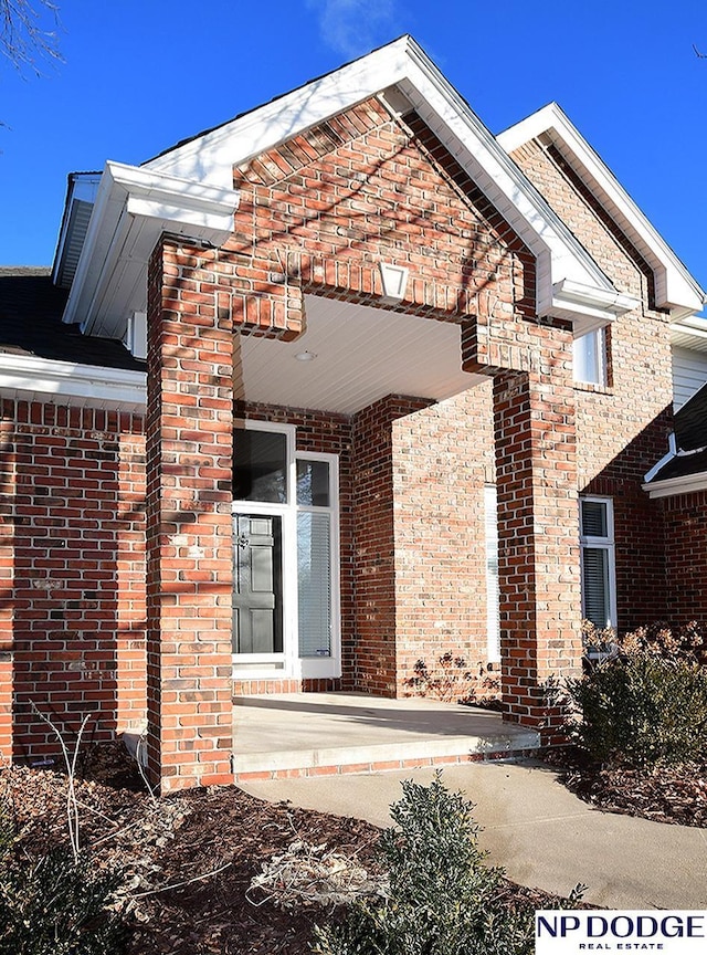 view of exterior entry featuring a patio area