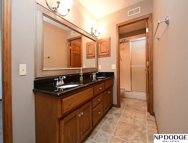 bathroom with toilet, walk in shower, and vanity