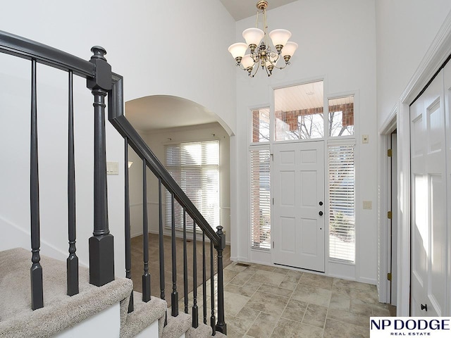 entrance foyer featuring a high ceiling and a chandelier