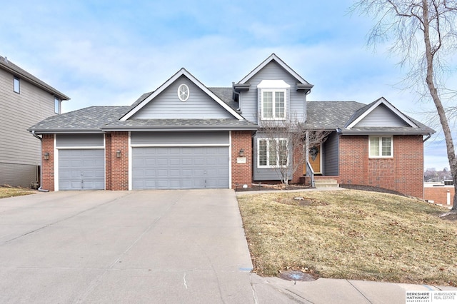 view of front of property featuring a front yard and a garage