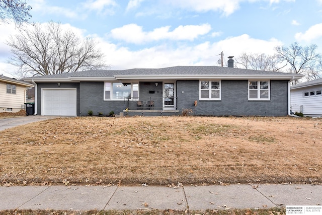 single story home with covered porch and a garage