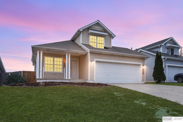 view of front of property with a lawn, a garage, and a porch