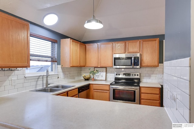 kitchen featuring decorative light fixtures, stainless steel appliances, tasteful backsplash, and sink