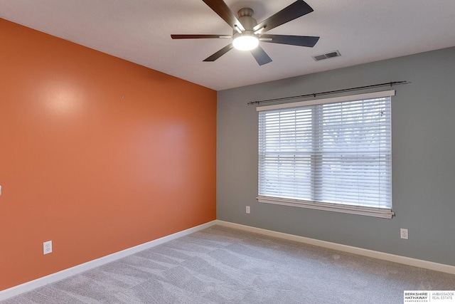 carpeted empty room featuring ceiling fan