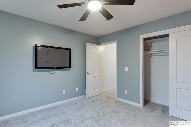 unfurnished bedroom with ceiling fan, light colored carpet, and a closet