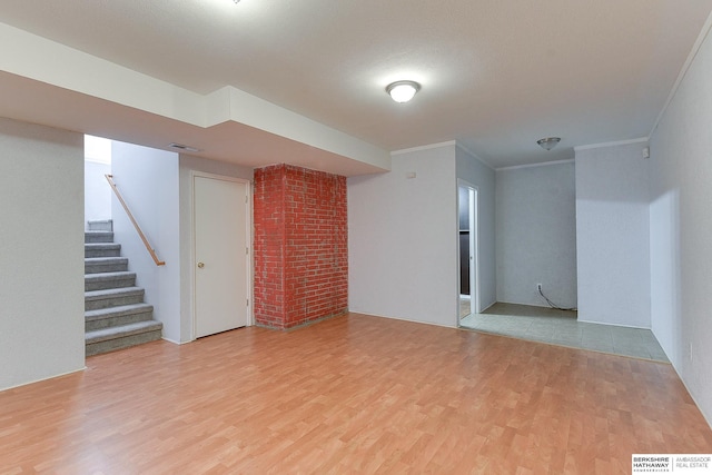 basement featuring hardwood / wood-style floors and ornamental molding