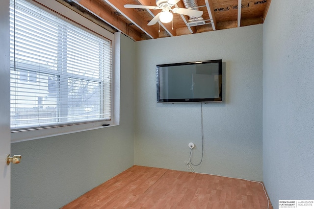 empty room with hardwood / wood-style floors and ceiling fan