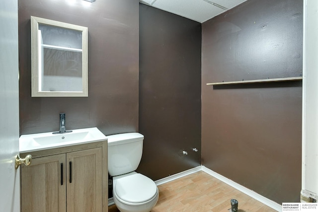 bathroom featuring toilet, hardwood / wood-style floors, and vanity