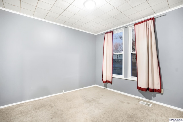 carpeted spare room with ornamental molding