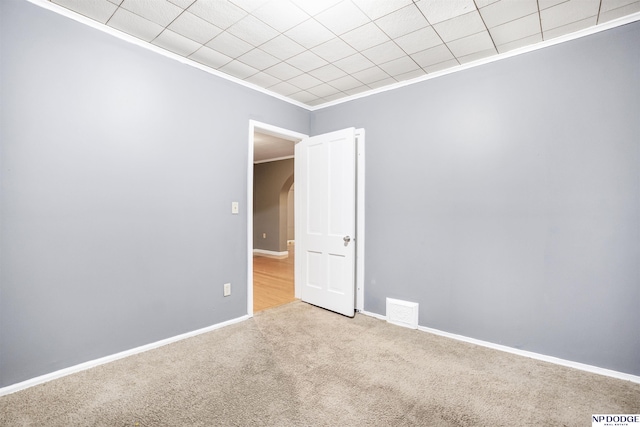 carpeted spare room with ornamental molding