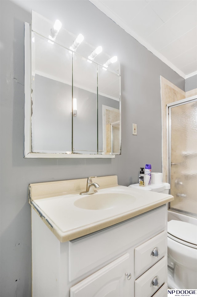 full bathroom featuring toilet, shower / bath combination with glass door, crown molding, and vanity