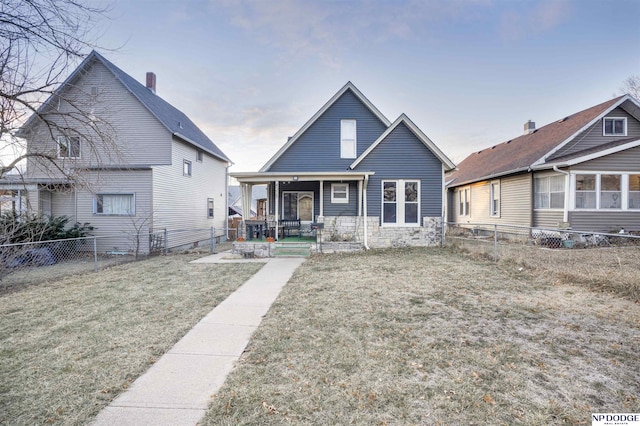 bungalow-style home featuring a porch and a front yard