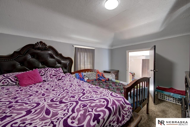 bedroom featuring carpet flooring and a textured ceiling