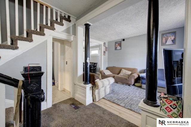 living room with a textured ceiling and hardwood / wood-style flooring