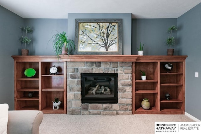 living room with a stone fireplace and carpet floors