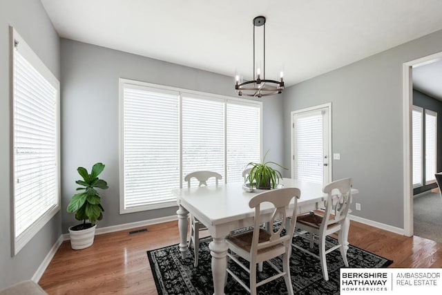 dining area featuring a chandelier and light hardwood / wood-style flooring