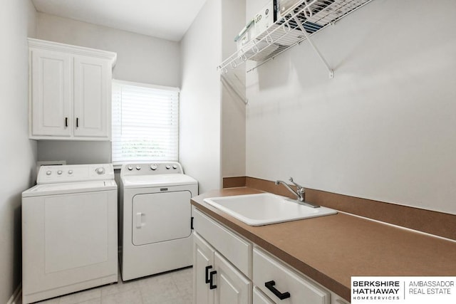 laundry room with sink, cabinets, and washer and dryer