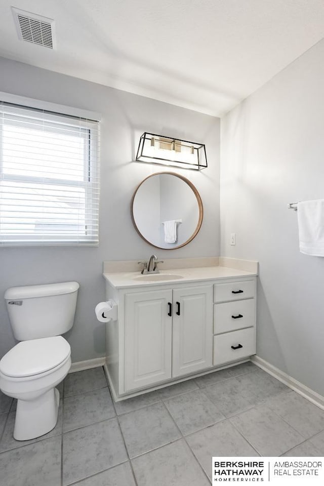 bathroom featuring toilet, vanity, and tile patterned flooring