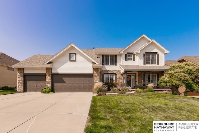 craftsman inspired home with a garage, covered porch, and a front lawn