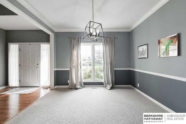 interior space featuring ornamental molding, an inviting chandelier, and carpet floors