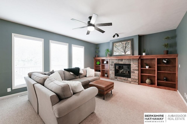 living room featuring ceiling fan, a wealth of natural light, and light carpet