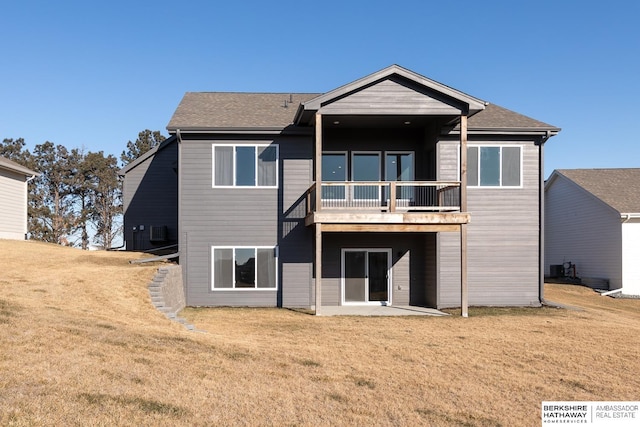 rear view of house featuring a lawn and a patio area