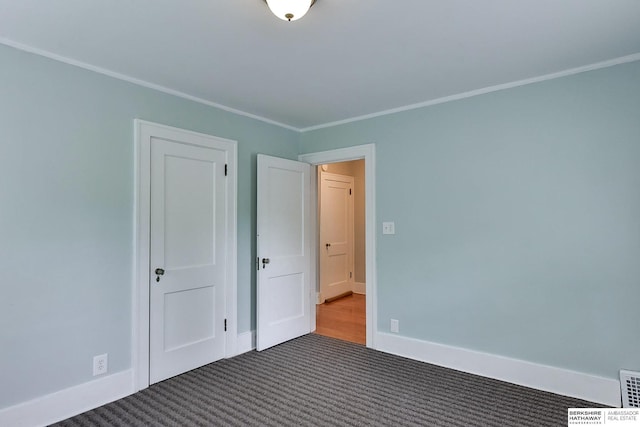 carpeted empty room with crown molding