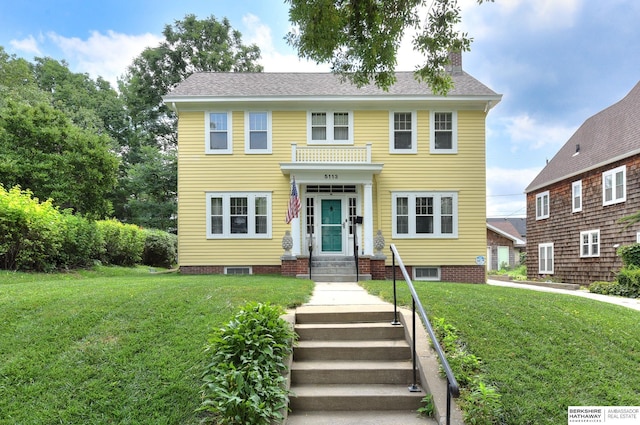 colonial inspired home with a front lawn