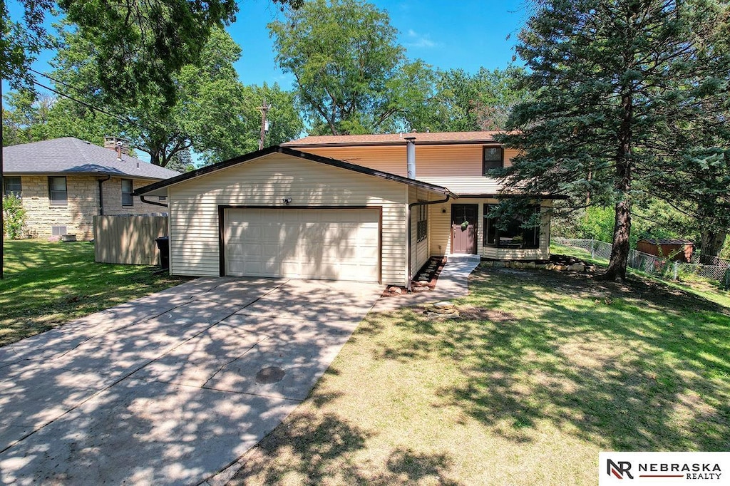 view of front of property with a front yard and a garage