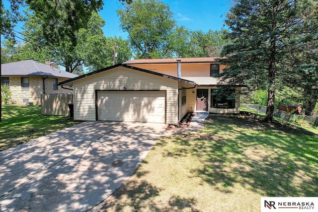 view of front of property with a front yard and a garage