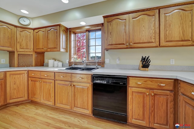 kitchen featuring light wood-type flooring, dishwasher, and sink