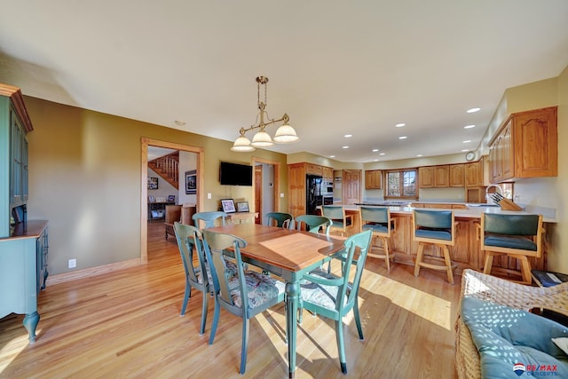 dining area featuring sink and light hardwood / wood-style flooring