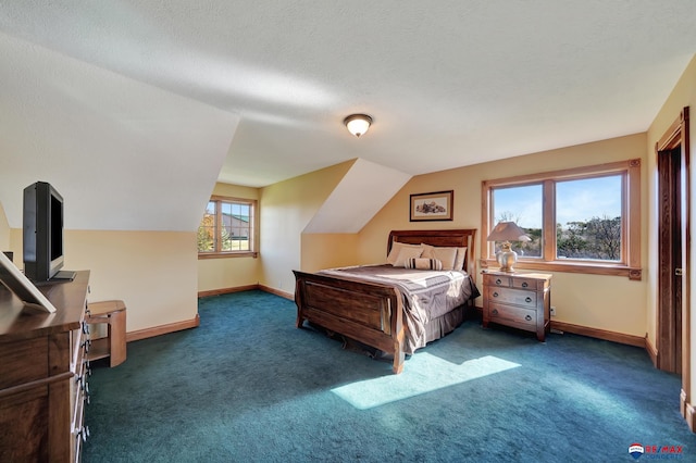 bedroom featuring lofted ceiling, a textured ceiling, and dark carpet