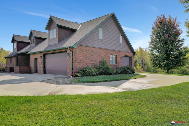 view of home's exterior featuring a lawn and a garage