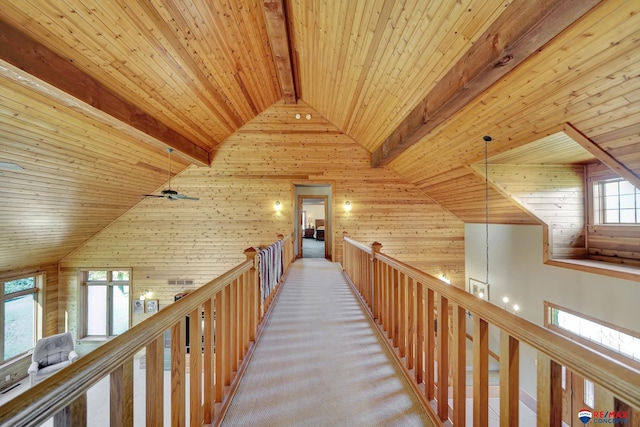 hall featuring high vaulted ceiling, wooden ceiling, carpet floors, and beamed ceiling