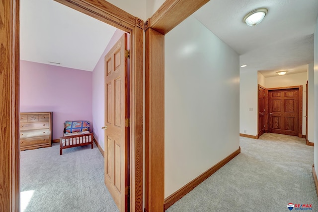 hallway with light colored carpet